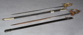 Two German Prussian WWI Swords, the hinged guard featuring a Prussian eagle, the wire wrapped handle with an applied crown. The blade is 32 inches lon