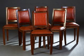 Set of Six French Art Deco Carved Beech Dining Chairs, c. 1940, the canted upholstered back over a curved cushioned seat, on reeded rounded square leg