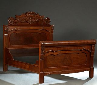 American Carved Walnut Highback Double Bed, late 19th c., the arched leaf and scroll crest above an inset paneled headboard, to bracketed wood rails a