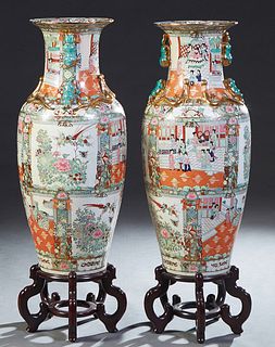 Pair of Large Chinese Famille Rose Baluster Palace Urns, 20th c., with an everted rim and integral gilt Foo dog handles, the shoulders with applied gi