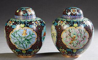 Pair of Black Cloisonne Baluster Covered Jars, 20th c., with floral and bird reserves, H.- 11 in. , Dia.- 9 in. Provenance: Property from a distinguis