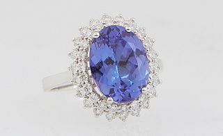 Lady's 14K White Gold Dinner Ring, with an oval 3.82 ct. tanzanite, atop a double graduated concentric border of round diamonds, total diamond wt.- .6