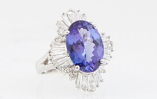 Lady's 14K White Gold Dinner Ring, with an oval 4.93 ct. tanzanite, atop a baguette and round diamond floret, total diamond wt.- 1.3 cts., Size 6 1/2,