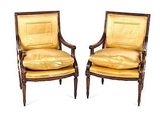 A Pair of Louis XVI Style Walnut Fauteuils Height 36 inches.