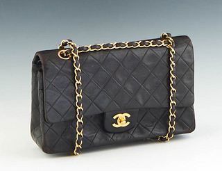 Classic Double Flap Chanel Shoulder Bag, in black quilted lambskin calf leather with gold hardware, opening to a maroon leather lined interior, accomp