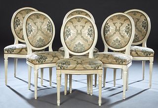 Set of Six French Louis XVI Style Carved Beech Dining Chairs, 20th c., the canted cushioned oval medallion back over a bowed upholstered seat, on turn