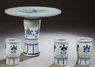 Chinese Porcelain Four Piece Patio Set, 20th c., consisting of a circular table with bird and floral decoration and three cylindrical stools, H.- 29 1
