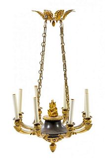 An Empire Gilt and Patinated Bronze Eight-Light Chandelier Height 34 1/2 x Diameter 20 1/2 inches.