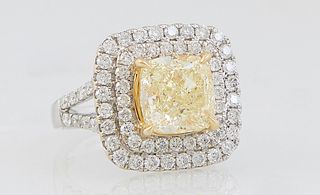 Lady's 18K White Gold Dinner Ring, with a center cushion cut 4.03 carat fancy yellow diamond, atop a square double concentric graduated round diamond 