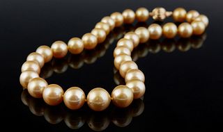 Graduated Strand of Thirty-Three Natural Golden Tahitian Cultured Pearls, ranging from 11-13mm, with a 14K white gold ball clasp, L.- 18 in. with appr