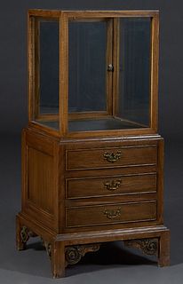 Upright Carved Oak Store Display Cabinet, with a glass top, sides and back over two rear doors, the front with three faux drawers, on block feet with 