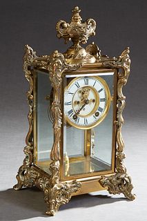 Ansonia Bronze and Crystal Regulator Mantel Clock, c. 1900, with a floral relief urn surmount, over beveled glass sides, and an open escapement time a
