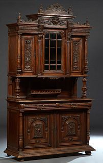 French Henri II Style Carved Walnut Buffet a Deux Corps, c. 1880, the finialed crest over a stepped breakfront crown above a setback central beveled g