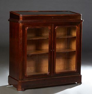 Unusual French Carved Walnut Vitrine, late 19th c., the glazed slanted top opening for display, over double curved corner glazed doors, flanked by can