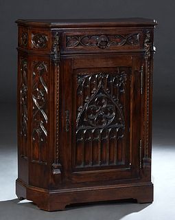 French Provincial Carved Oak Gothic Style Confiturier, 19th c., the stepped canted corner hexagonal top over a frieze drawer, above a Gothic quatrefoi