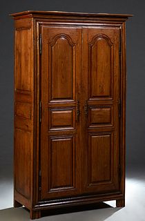 French Provincial Carved Oak Armoire, 19th c., the stepped crown over double three fielded panel doors with iron fiche hinges and escutcheons, flanked