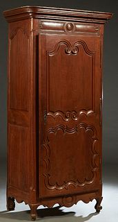 French Louis XV Style Carved Cherry Bonnetiere, the stepped rounded corner ogee crown over a double fielded panel door with iron fiche hinges and escu