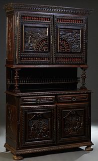 French Henri II Style Carved Oak Buffet a Deux Corps, c. 1880, the stepped dentillated crown over double spindled cupboard doors with relief carved sc