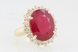 Lady's 14K Yellow Gold Dinner Ring, with an oval 10.86 carat oval ruby atop a border of round diamonds, total diamond wt.- 1.29 cts., Size 6 1/2, with