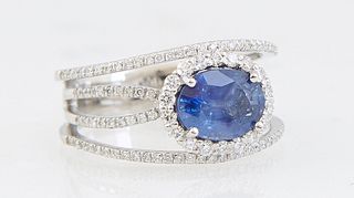 Lady's Platinum Dinner Ring, with an oval 2.17 carat blue sapphire, atop four pierced narrow diamond mounted borders, total diamond wt.- .62 cts., Siz