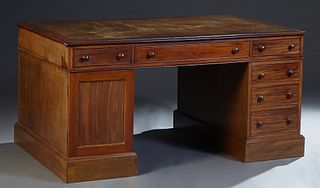 Georgian Style Carved Mahogany Partner's Desk, 20th c., the inset gilt tooled green leather top over three frieze drawers on each side over double ped