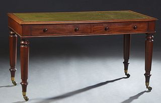English Victorian Carved Mahogany Writing Table, late 19th c., the stepped ogee top with three inset gilt tooled green leather writing surfaces, over 