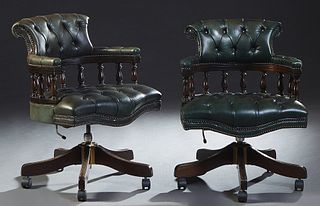 Pair of English Green Leather Swivel Barrel Back Armchairs, 20th c., having a buttoned back and contiguous leather upholstered curved arms, over a spi