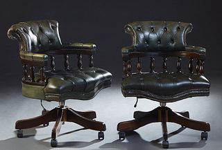 Pair of English Green Leather Swivel Barrel Back Armchairs, 20th c., having a buttoned back and contiguous leather upholstered curved arms, over a spi