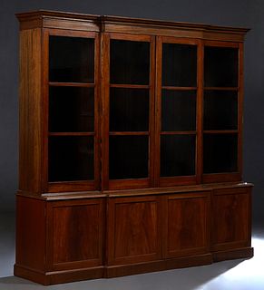 Georgian Style Carved Mahogany Breakfront Bookcase, 20th c., the stepped breakfront crown over two central three panel glazed doors, flanked by two li