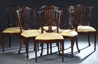 Set of Six Adams Style Carved Mahogany Dining Chairs, 20th c., the arched curved canted shield shaped back with a pierced splat, above a shaped bowed 