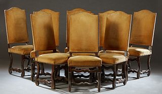Set of Nine French Louis XIII Style Carved Oak Dining Chairs, 20th c., the arched canted high cushioned back over a trapezoidal cushioned seat, on cab