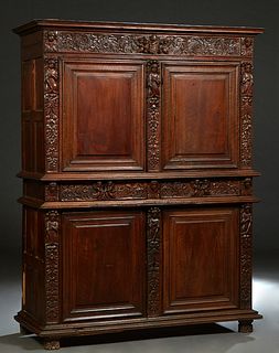 French Henri II Carved Walnut Buffat a Deux Corps, c. 1880, the stepped crown over a figural and floral carved frieze above double fielded panel cupbo
