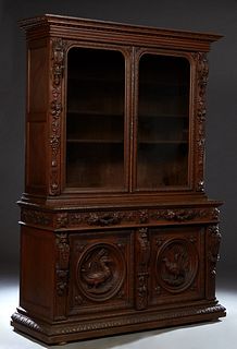 French Provincial Henri II Style Carved Oak Buffet a Deux Corps, c. 1880, the stepped crown above two rounded corner glazed doors, flanked by high rel