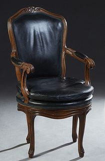 Louis XV Style Swivel Desk Chair, 20th c., the arched floral carved crest rail over a cushioned back, to upholstered curved arms, above a removable se