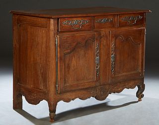 French Provincial Carved Oak Louis XV Style Sideboard, 19th c., the stepped rectangular top over three frieze drawers with iron escutcheons above doub