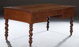 French Henri II Style Carved Oak Desk, c. 1880, the stepped edge top over a central frieze drawer, flanked by a deep drawer proper left and two shallo