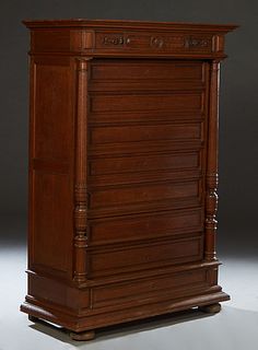 French Provincial Henri II Style Carved Oak Semainier, late 19th c., the stepped edge top over a frieze drawer and seven deep drawers, flanked by turn