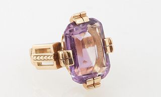 Lady's 14K Yellow Gold Art Deco Style Dinner Ring, with an app. 13 ct. emerald cut amethyst, on four double prongs, with pierced lugs on each side, Si