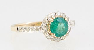 Lady's 14K Yellow Gold Dinner Ring, with a round .76 ct. emerald atop a border of round diamonds, the shoulders of the band also mounted with round di