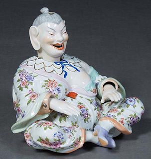 A Dresden Porcelain "Nodder" Figure, 20th c., after the Meissen model, the seated figure with moving head and hands, having Dresden mark in underglaze
