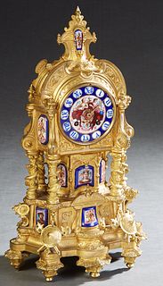 M. T. Kaltenberger Gilt Bronze and Porcelain Mantel Clock, 19th c., the arched top with a painted porcelain inset spire, over a hand painted dial with