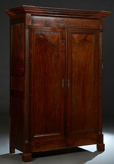 French Empire Style carved Walnut Armoire, 19th c., the stepped crown over setback double doors,flanked by demilune engaged reeded columns, on a plint