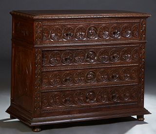 French Provincial Henri II Style Carved Oak Commode, c. 1880, the stepped carved edge top over a relief carved figural and floral carved frieze drawer