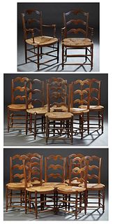 Unusual Set of Fifteen French Provincial Carved Walnut Rush Seat Dining Chairs, early 20th c., consisting of thirteen side chairs and two fauteuils, t