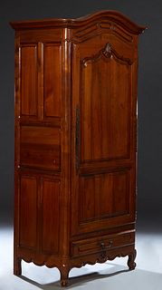 French Provincial Louis XV Style Carved Cherry Bonnetiere, 19th c., the stepped arched crown over arched fielded two panel doors with long iron fiche 