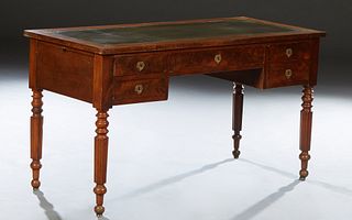 French Louis Philippe Style Carved Walnut Desk, early 20th c., the rectangular top with an inset gilt tooled green leather writing surface, over a cen