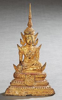 Thai Gilt Bronze Seated Buddha Figure, early 20th c., on a graduated stepped throne, H.- 7 in., W.- 3 3/4 in., D.- 1 3/4 in. Provenance: Property from