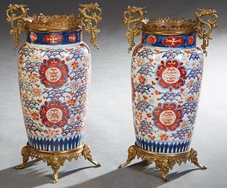 Pair of Large Gilt Bronze Mounted Imari Baluster Porcelain Vases, 20th c., with gilt bronze dragon handles, over sides with painted butterfly and clou
