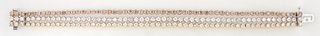 Unusual 18K White Gold Link Bracelet, composed of three parallel strands of fifty-six prong set white, light yellow, and light brown diamond mounted r