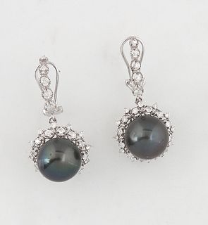 Pair of 14K White Gold Earrings, with a 13.6mm gray Tahitian cultured pearl, atop a border of round diamonds separated by diamond mounted points, susp